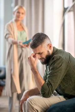 Bearded man feeling upset while speaking with psychoanalyst Stock Photos