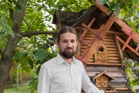 A bearded man in front of a windmill Stock Photos