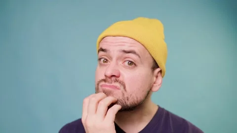 A bearded man with a funny expression, making a comic grimace while in a studio Stock Footage 304808252