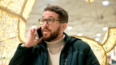 Bearded man in glasses is talking on a smartphone. Stock Footage 102897662