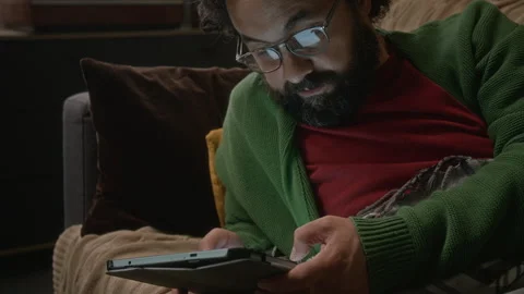 Bearded Man with Glasses Using Tablet Computer for Remote Work Stock Footage 341673305