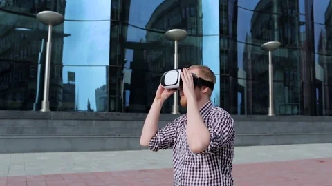 A bearded man with glasses virtual reality outdoors Stock Footage