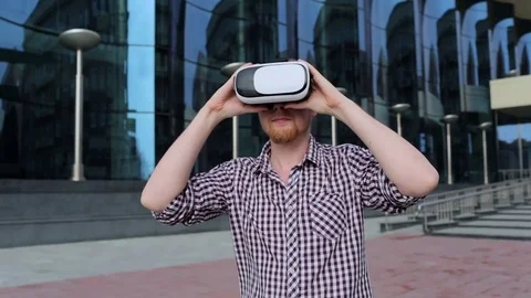 A bearded man with glasses virtual reality outdoors Stockbeeldmateriaal 74488503