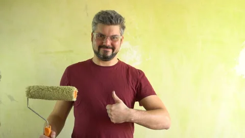 Bearded man in glasses on a wall background shows class 4K Stock Footage 125282966