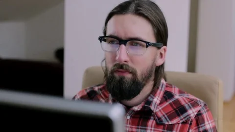 Bearded man in glasses working in office Stock Footage 73178184