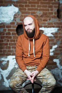 Bearded man. A guy on a brick wall background Foto stock
