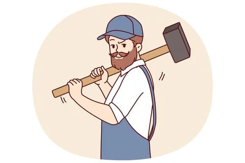 Bearded man with hammer works at construction site, dressed in overalls wi... Stock Photos