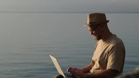 Bearded man in hat working outdoor. Digital nomad and solo travel concept. Stock Footage 266486518
