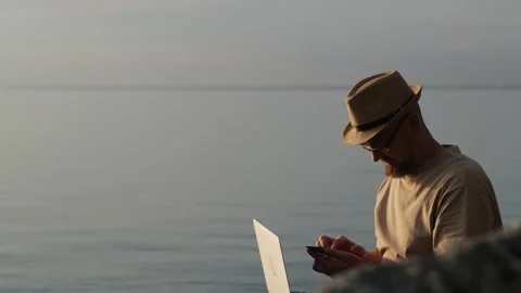 Bearded man in hat working outdoor. Digital nomad and solo travel concept. Stock Footage 271222378