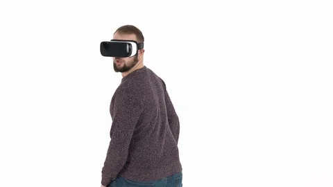 Bearded man is having fun with virtual reality glasses moving his body and Stock Footage 121194012