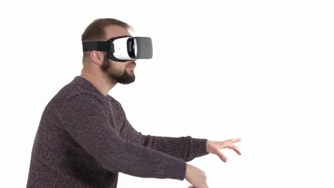 Bearded man is having fun with virtual reality glasses. Hipster guy imitating Video stock 121194517