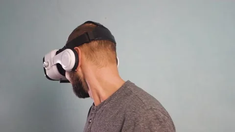 A bearded man is having fun wearing virtual reality glasses. Virtual reality Stock Footage 146754945