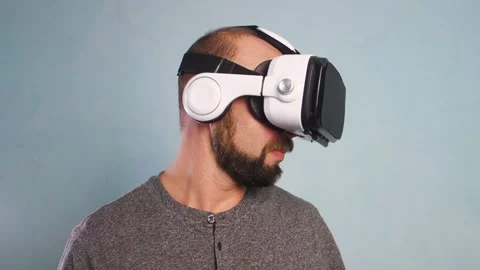 A bearded man is having fun wearing virtual reality glasses. Virtual reality Video stock 146965476