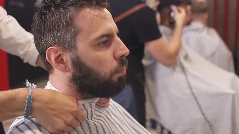 Bearded man having his beard cut by hairdresser at the barbershop 스톡 동영상 93711071