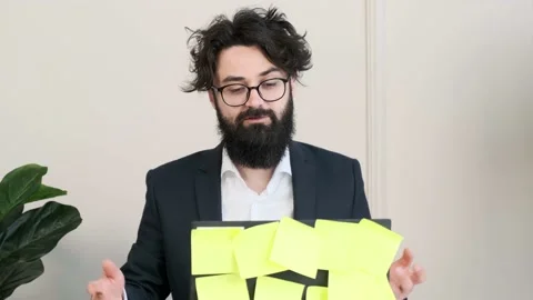Bearded man having a video call conference, trying to explain something. Stock Footage 155807833