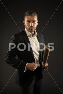 Bearded man hold baseball bat. Businessman with bat weapon. Aggression or Stock Photos