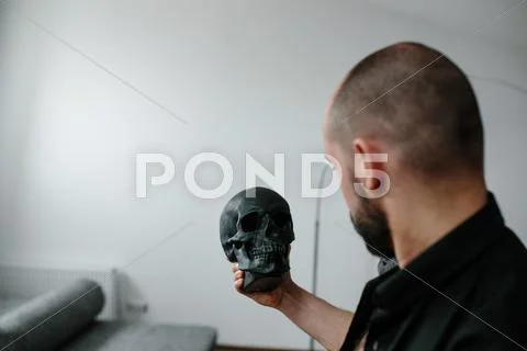 Bearded Man Holding Skull