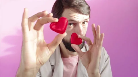 Bearded man holding small red hearts shape in hands happy valentines day concept Stock Footage 120563953