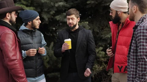 Bearded man holds cup of coffee explaining situation Stock Footage 285397591