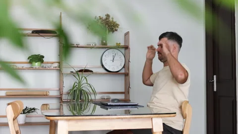 Bearded man at home shuts down laptop with satisfaction. Stock Footage 310932703