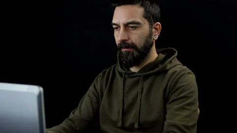 Bearded man on isolated black background working with laptop. Stock Footage 144206933