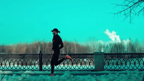 Bearded man jogging on blue sky background Stock Footage 140773212