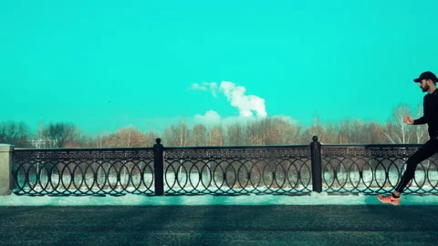 Bearded man jogging on blue sky background Stock Footage 140773219