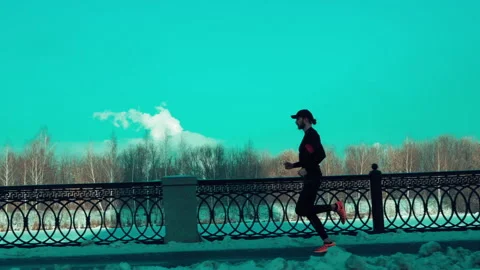 Bearded man jogging on blue sky background Stock-Footage 140773257