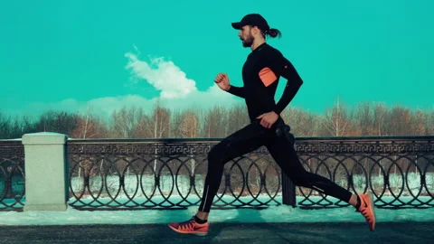 Bearded man jogging on blue sky background Stock Footage 140773402