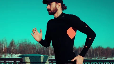 Bearded man jogging on blue sky background Stock Footage 140773785