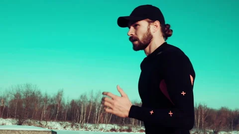 Bearded man jogging on blue sky background Stock Footage 140773850