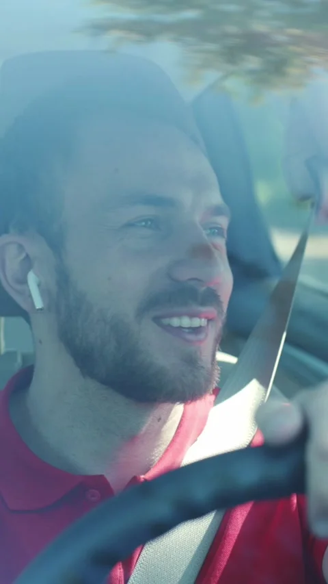 A bearded man joyfully drives, showcasing freedom and enjoyment Stock Footage 314159523