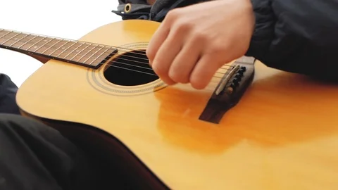 Bearded man in a knitted hat playing a guitar and singing Stock Footage 103141133