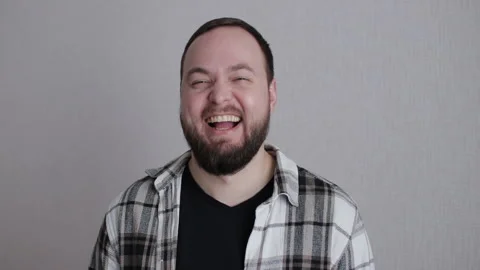 Bearded man laughing during professional studio portrait shoot Stock Footage 300079512