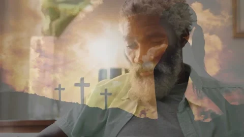 Bearded man leaning reading devotional then tapping smartphone with sunrise Stock Footage 317116883