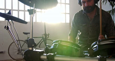 Bearded man learning play electronic drums music at living room at home. Self 스톡 동영상 132363870