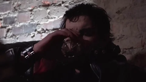 Bearded man in a leather jacket drinks whiskey in a room loft style Vídeo Stock 84184706