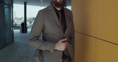 A bearded man, with a light brown suit Stock Footage 142164568