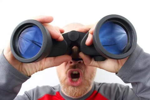 Bearded man looking through binoculars on white background Stock Photos