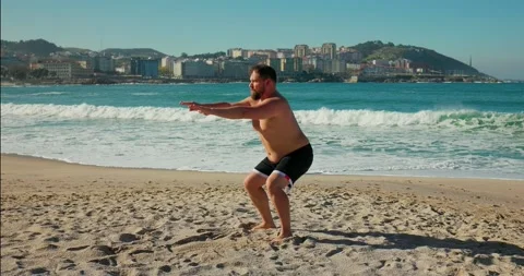 A bearded man with a lot of weight does squats. Stock Footage 171527561