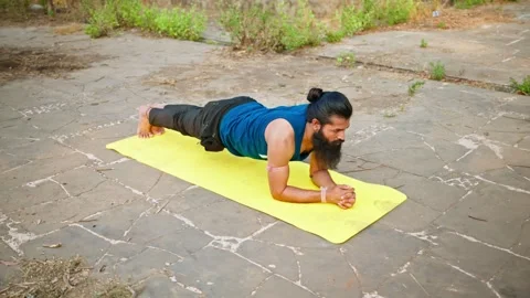 Bearded man maintain core stability in exercise at park Stock Footage 303129073