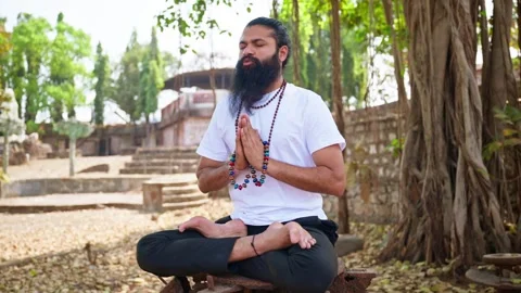 Bearded man meditates in lotus position at retreat Stock Footage 305367367