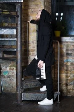 A bearded man with a mini piano. Stock Photos