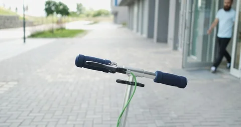 Bearded man moves around the city on scooter, goes on business, leaves the store Stock Footage 115938853