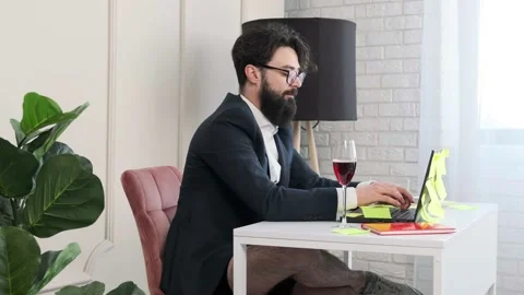 Bearded man with no pants close the computer and enjoy a glass of wine. Stock Footage 155642094