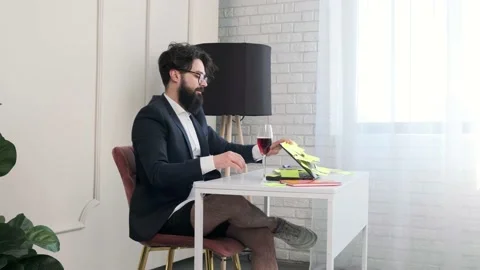 Bearded man with no pants close the computer and enjoy a glass of wine. Stock Footage 156327921