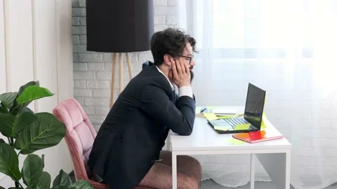 Bearded man with no pants having a video call conference, man is tired and falls Stock Footage 168975948
