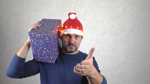 Bearded man offering a gift 4K Stock Footage 142406670