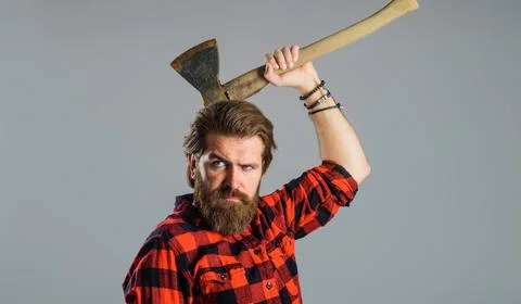 Bearded man with old axe. Man in checkered shirt use axe. Brutal lumberjack.  Stock Photos