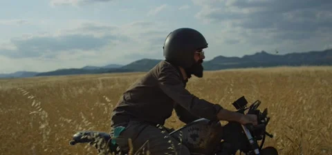 Bearded man on old cafe racer motorcycle in wheat field Stock Footage 140622710